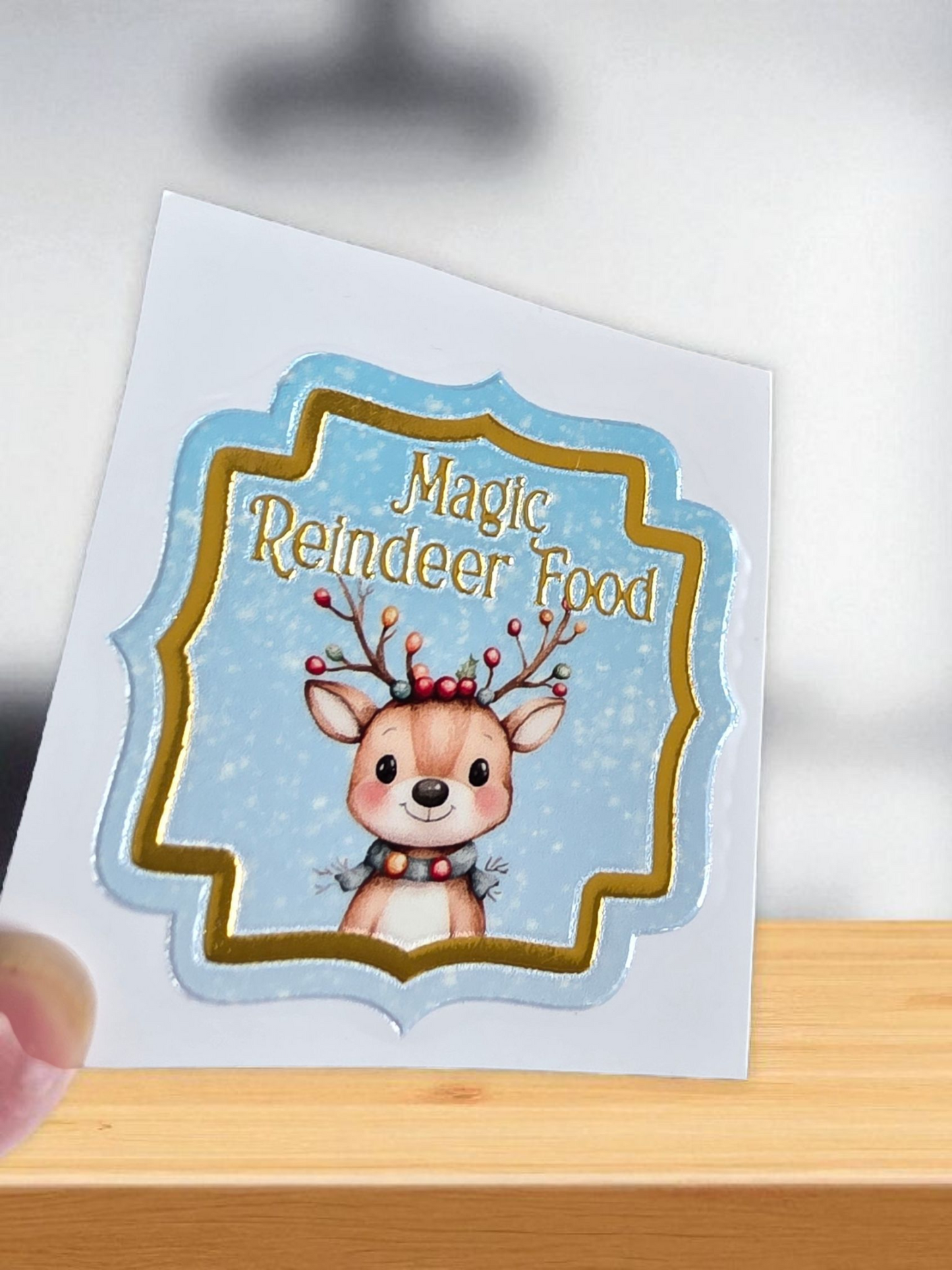 Sticker with a reindeer design and 'Magic Reindeer Food' text on a white background.